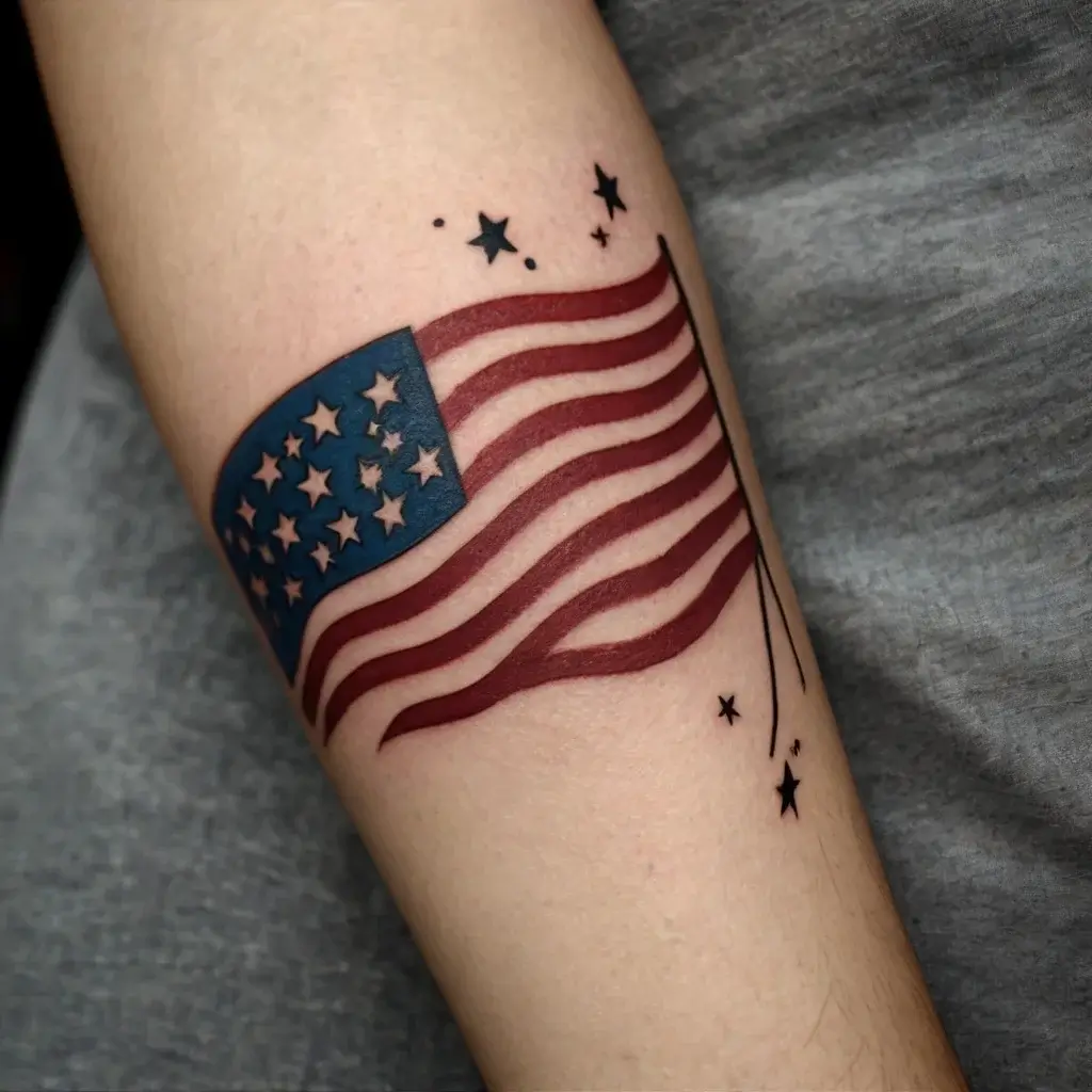 Tattoo of a wavy American flag in red, white, and blue, with black star accents trailing like a comet.