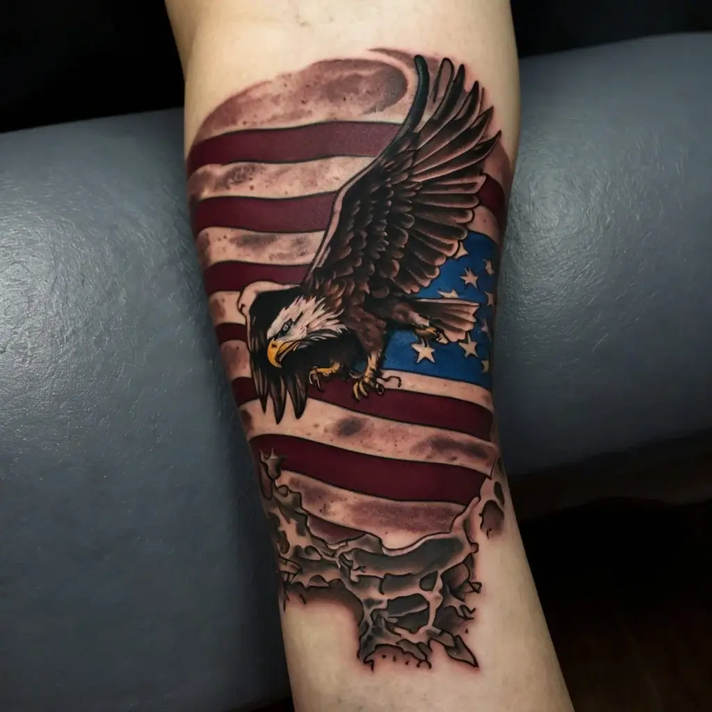 Tattoo of a bald eagle soaring over a tattered American flag with red, white, and blue, symbolizing freedom and patriotism.